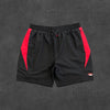 SYNA WORLD VORTEX WOVEN SHORT [BLACK/RED]